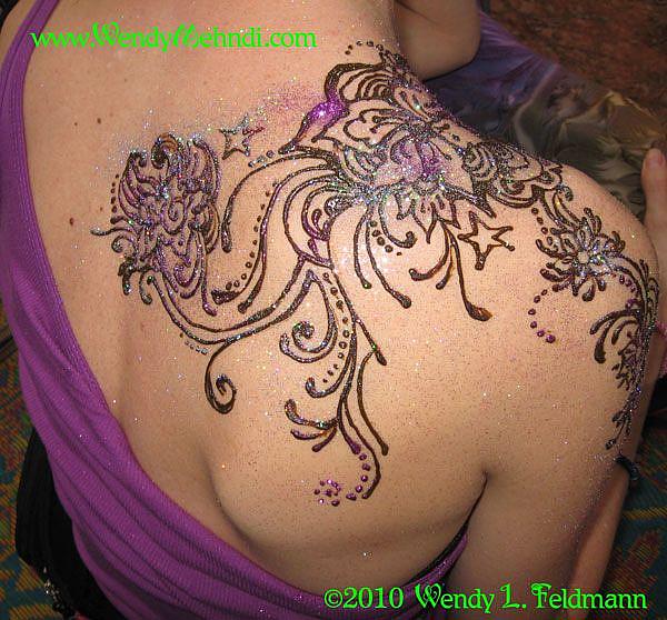 Henna design wrapping over a shoulder